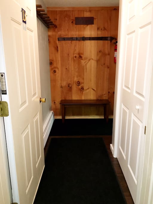 Entryway bench with ski rack and coat rack.