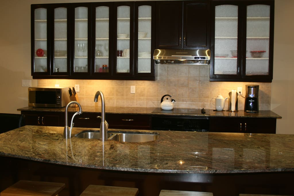 A huge island makes the difference in the kitchen. Granite tops are everywhere.