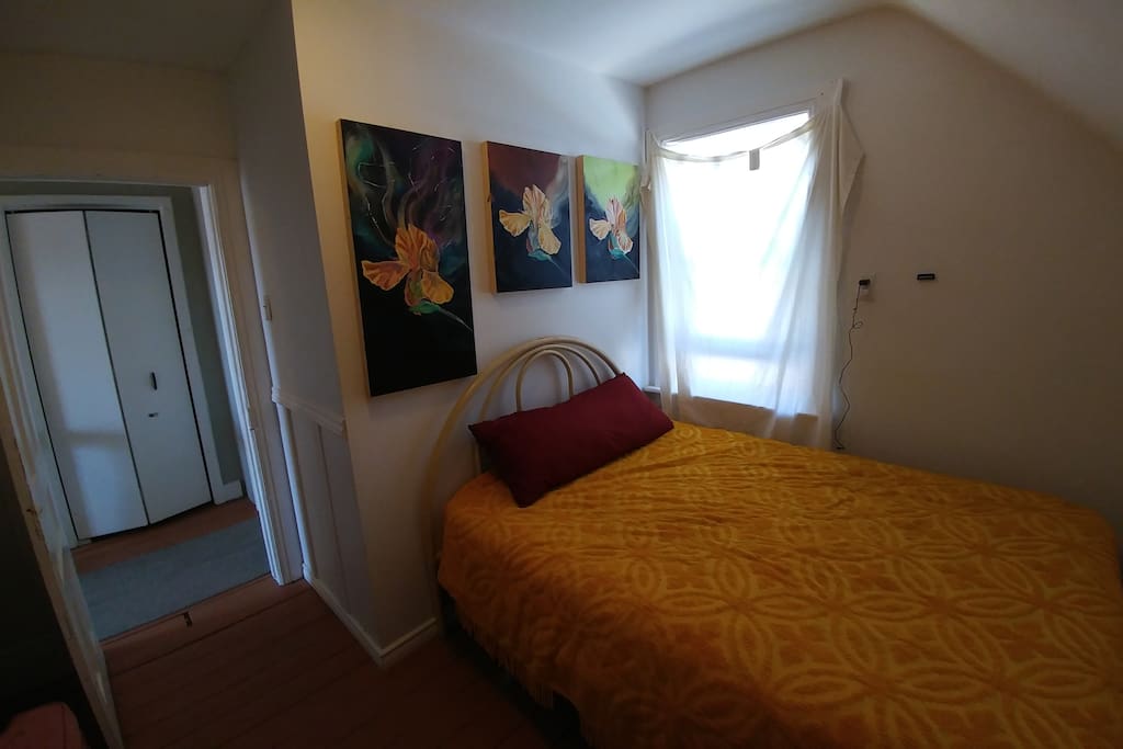 Bedroom with double bed and sofa.