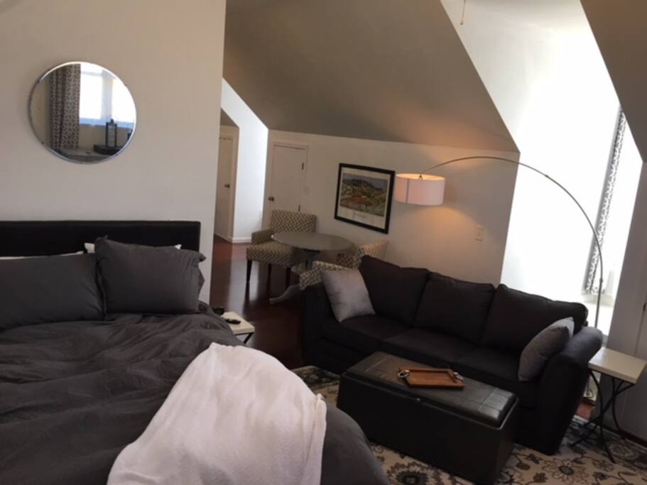 Queen size bed, desk, couch, and bench.