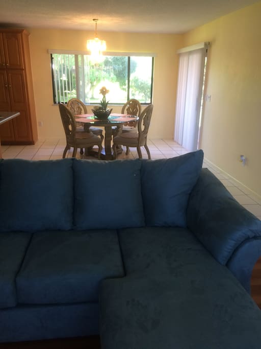Living room chaise lounge sofa and view to dining room