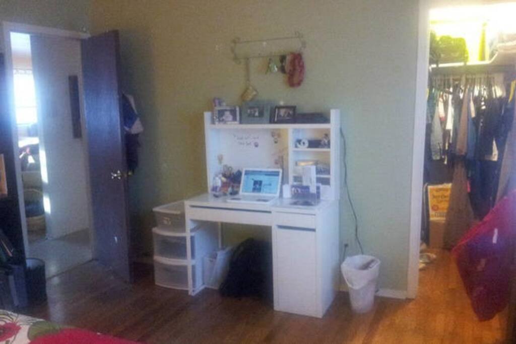 Desk and hooks on the wall for keys, wallets, purses, etc.