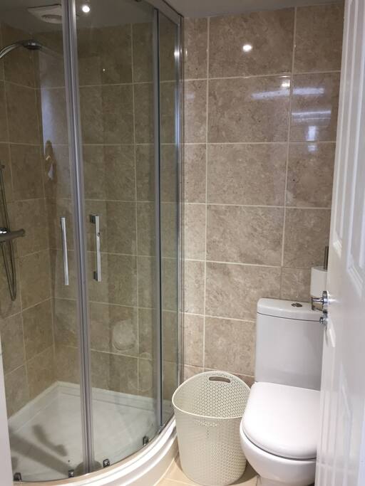 Bathroom with shower toilet laundry basket