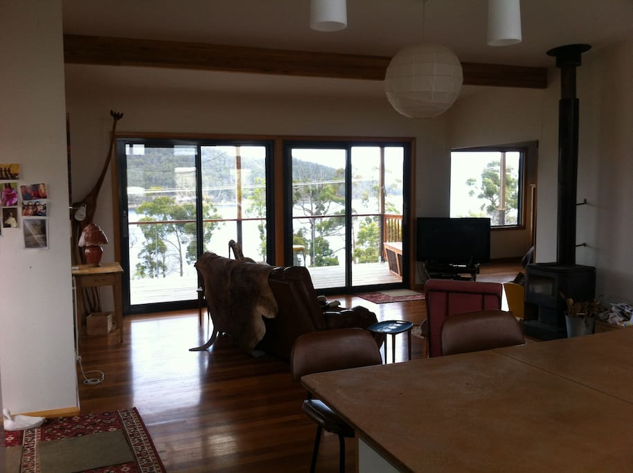 Open plan living area, with wood burning stove overlooking the huon estuary