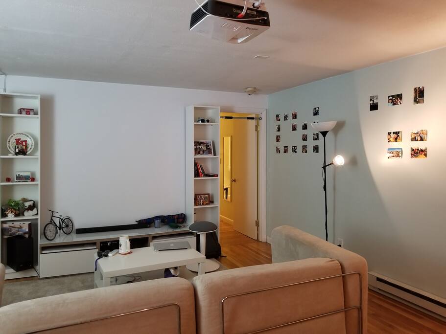 Living area with projector on top and entrance to bedroom