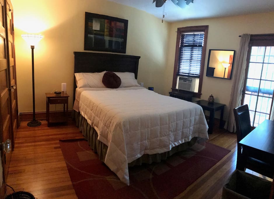 The large back bedroom offers a queen bed and private porch