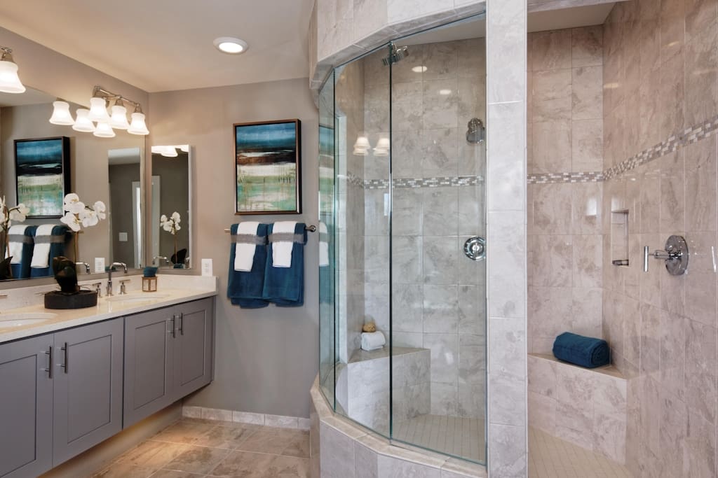 Masterbedroom bath, double vanity, double shower heads and toilet located inside water closet.