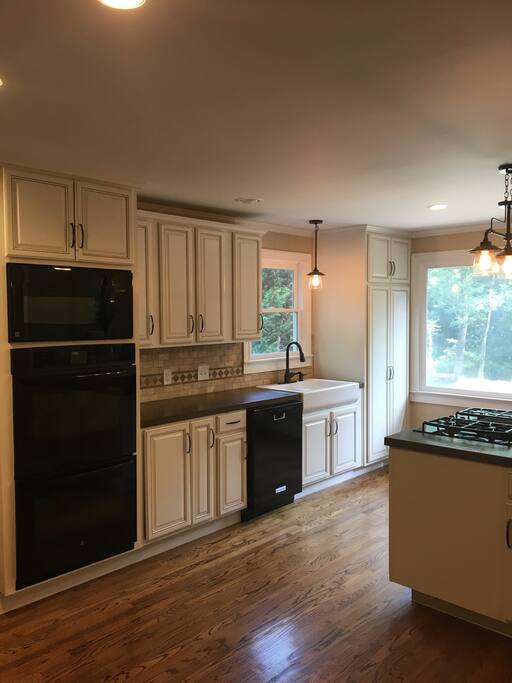 The kitchen is both beautiful and functional with concrete counter tops, double ovens and the cabinets are stocked with everything you need to entertain.