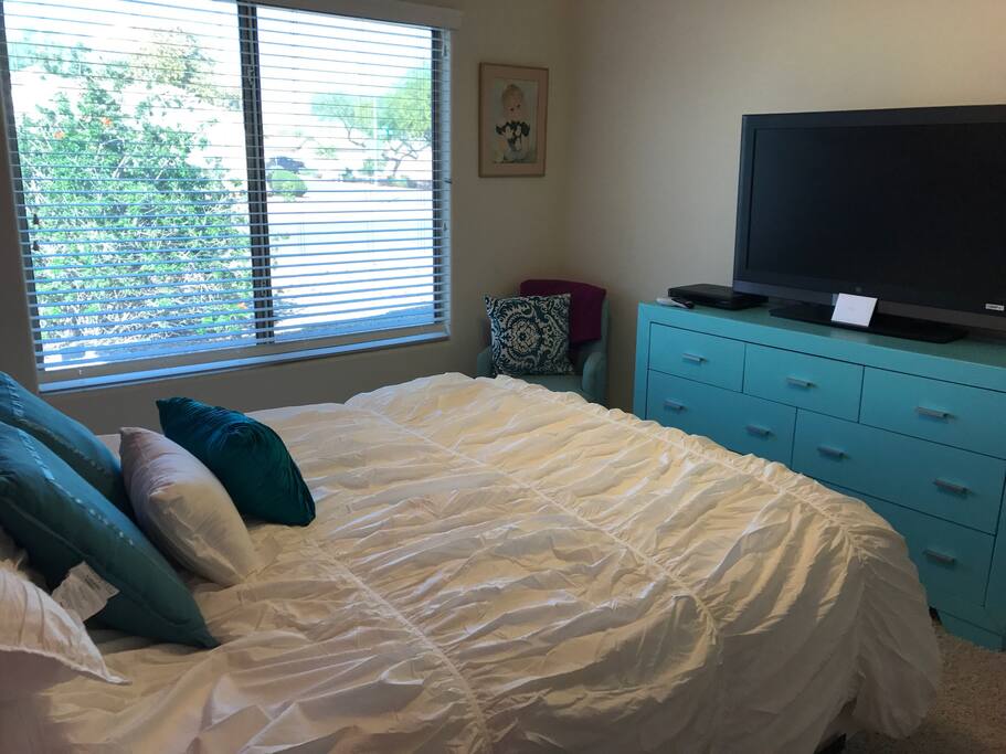 Room has a tv with direct tv and dresser with lots of storage.