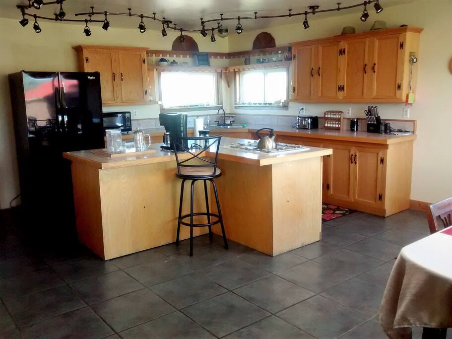 Large kitchen with a double oven and gas range.
