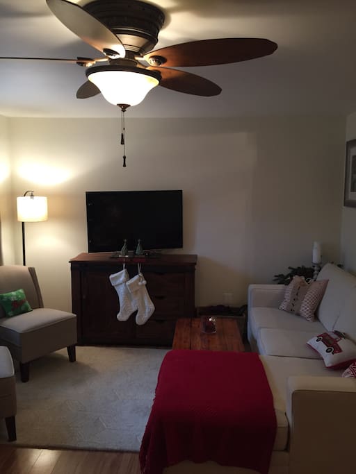 Family room with tv, couch and 2 charis