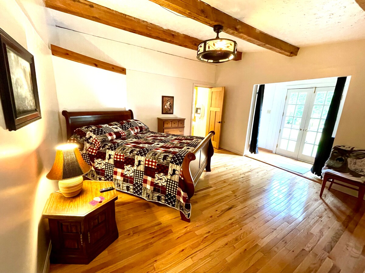 The master bedroom offers a queen sized bed and Roku TV, it adjoins the bathroom. French doors lead to the outside deck. 