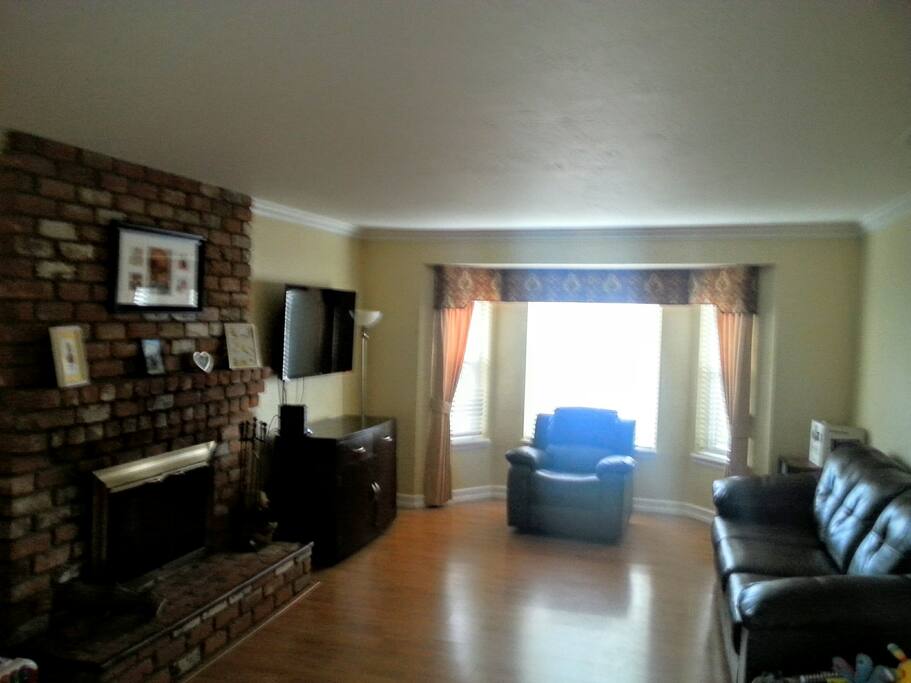 Living room with fireplace & TV