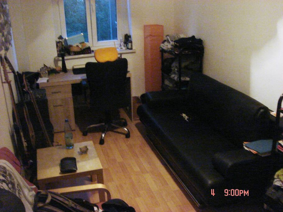 Your private Room with Couch for Sleeping, Table for private Work and some Space for your Stuff.