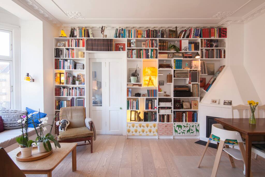 Living room with fireplace and sofa where 1 person can sleep