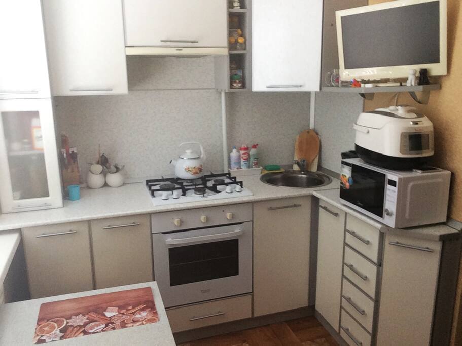 Room with sofa bed and kitchen and TV