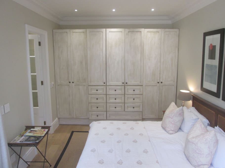 Spacious en-suite bedroom with French styled built in cupboards
