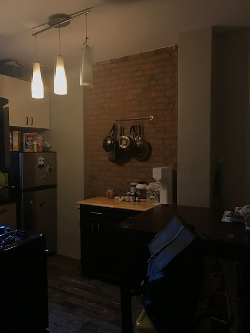 Exposed brick kitchen with stone flooring. Stainless steel amenities and fully stocked with latest appliances including Keurig, SodaStream, Bullet Blender and dishwasher.
