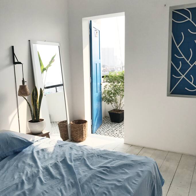 Double bedroom for 2 guests - Room for DREAMERS | with balcony view, an air-conditioner, one white rustic mirror, a hanger and other amenities.