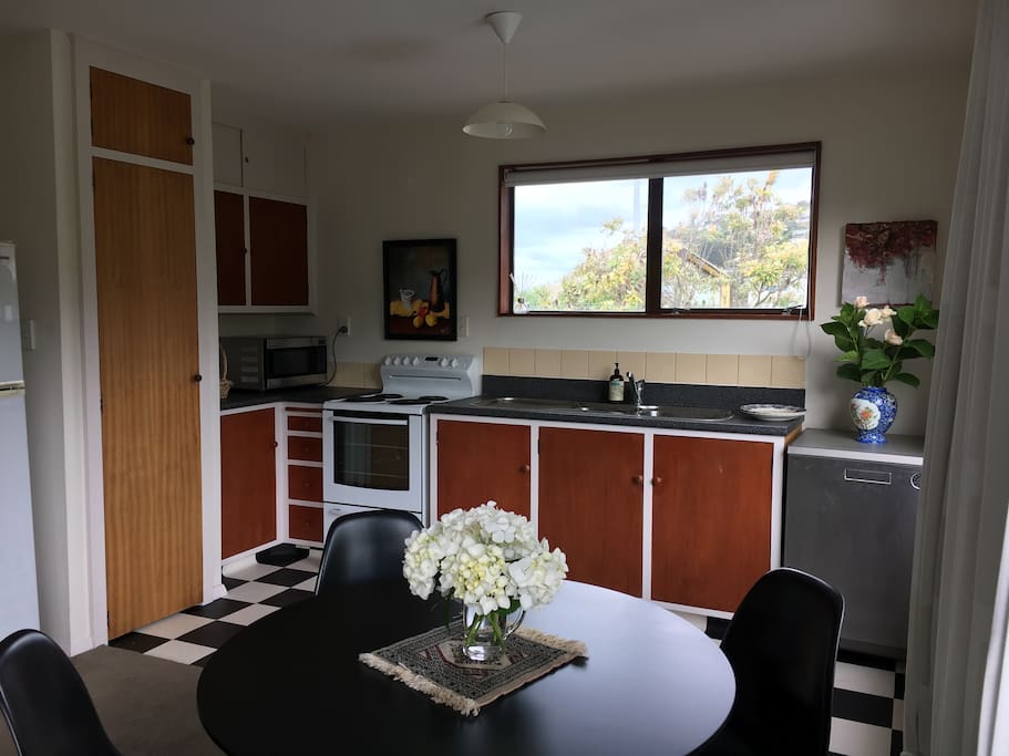 Kitchen looking over road to Moncks Bay and beach