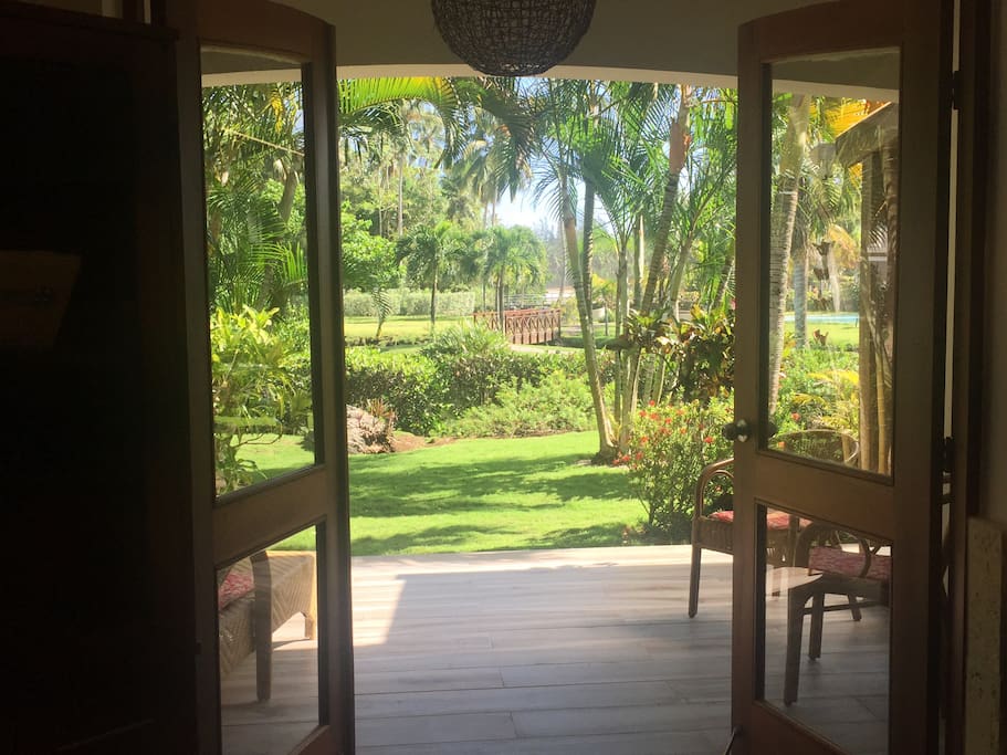 Main floor exit to the private covered lounging area, pool and beach