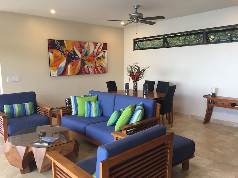 Simple clean living/dining space opens out to the pool deck.