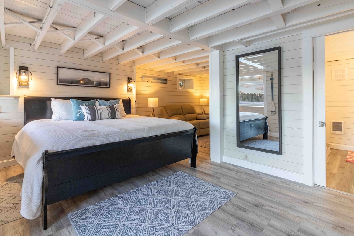 Dormitorio principal de nivel inferior con baño en suite (bañera, lavabo, inodoro). 