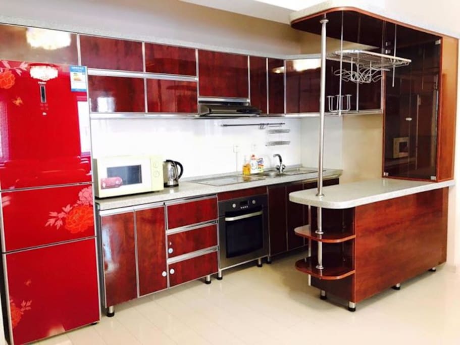 Kitchen area with stove, microwave, boiler, rice cooker, refrigerator