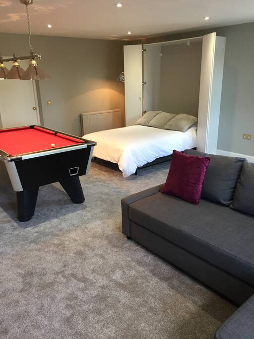 Spacious open plan living space with pool table