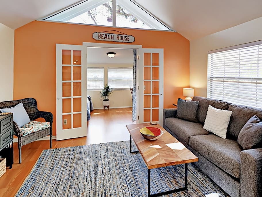 Welcoming living area with seating for 3 and a cheerful color palette.
