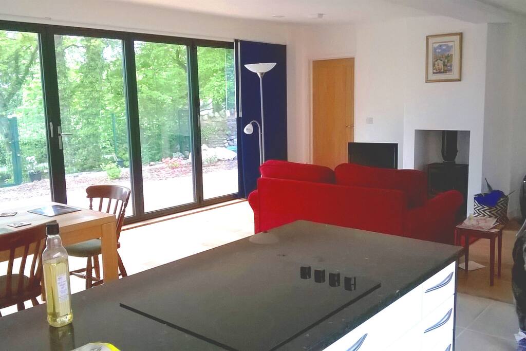 Canal-side view (windows see-out but not see-in) and woodburning stove in sitting area