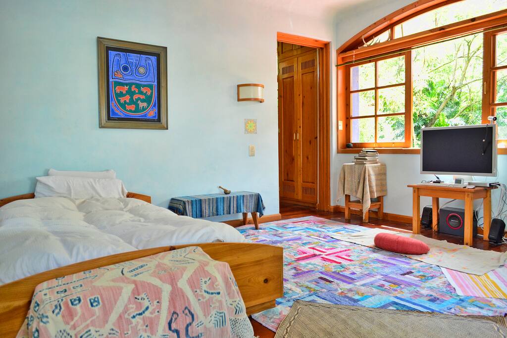 Main room, double bed and entrance. Plenty of sunlight through all windows