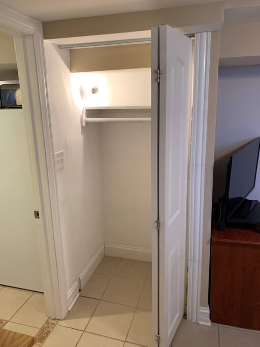 Closet just inside the room entry door with closet light on inside.
