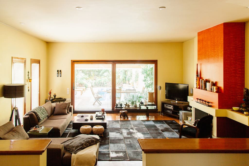 The summer set up: The living room, as seen from the dining room. The glass door brings light and a sense of connectedness to the nature and the water element of the garden.