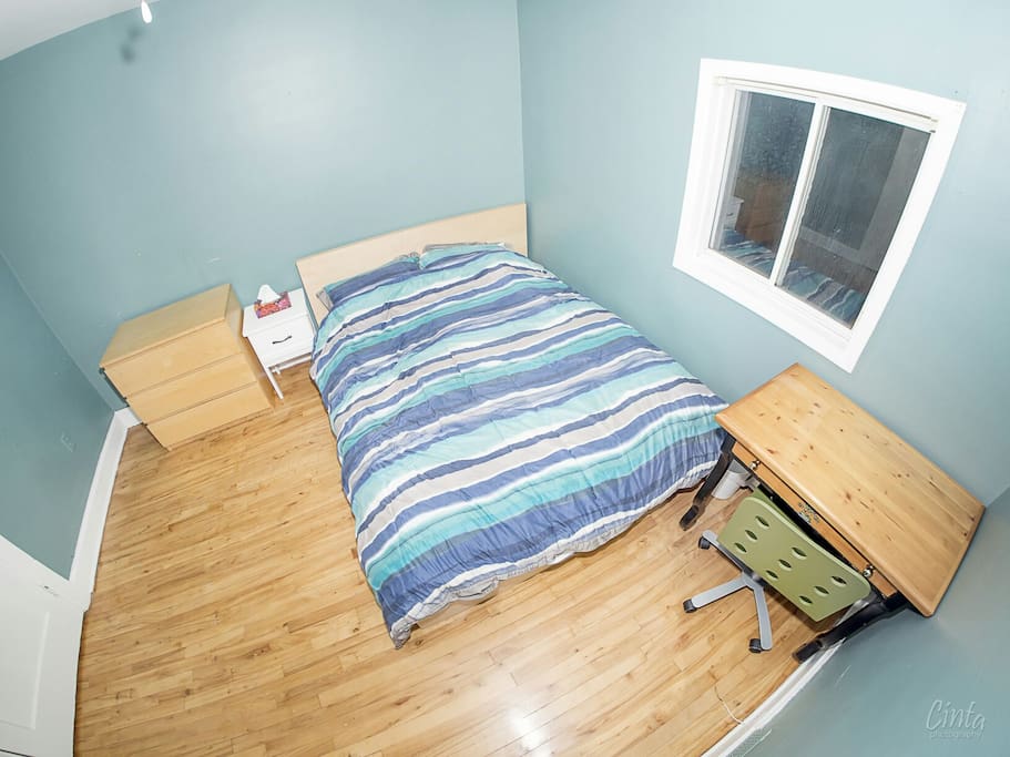 Private bedroom with queen size bed, closet, side table, dresser, desk and chair