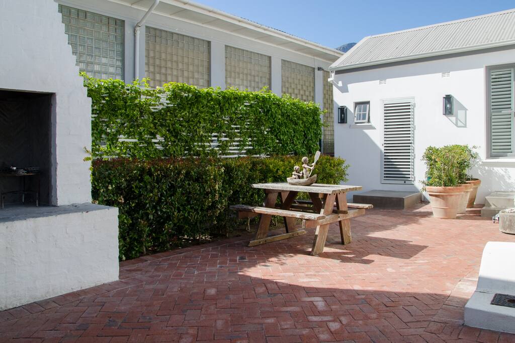 The cottage entrance and outdoor barbecue area