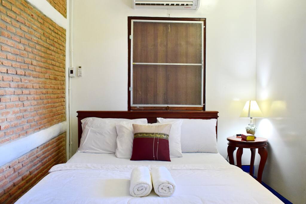 Queen size double bed, bedside table with lamp, wooden window shutters