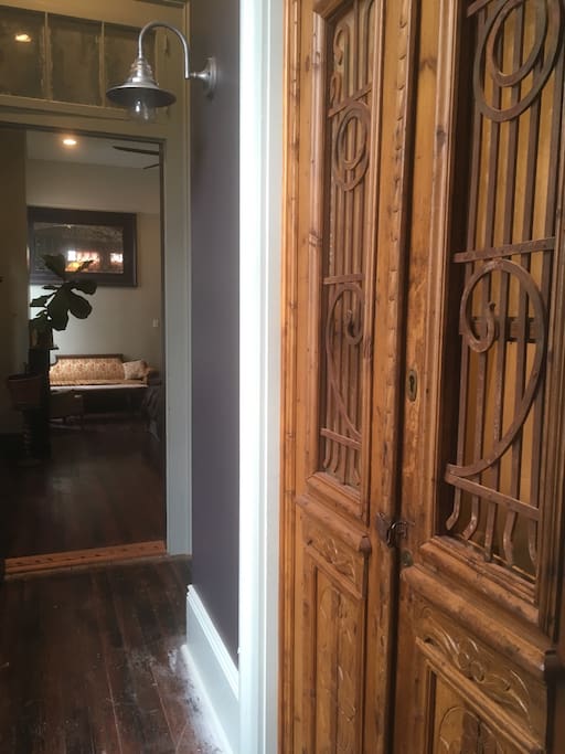 Antique doors at charm to the private bathroom.