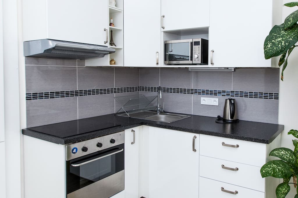 Kitchen with hob, microwave, kettle