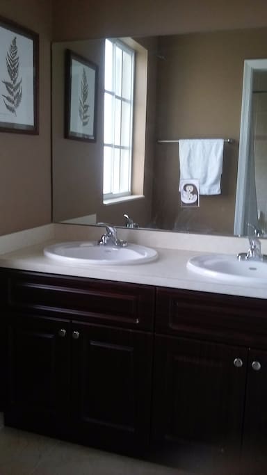 Private bathroom with double sink.