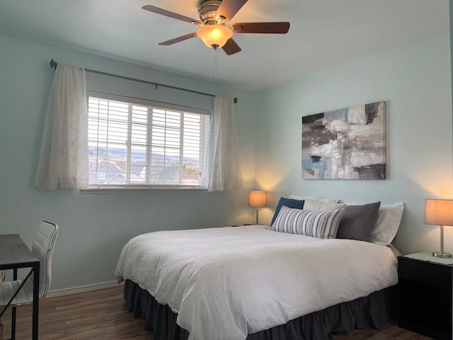 The upstairs corner bedroom sleeps two in a queen bed. Enjoy plenty of light by day for work or study, and quiet privacy at night. Closet space is available and bathroom is across the hall. Craft supplies and toys are available for ages 2-12.