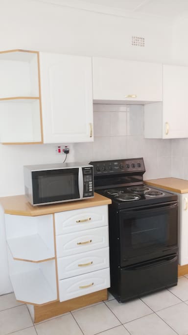 Kitchen with stove,microwave