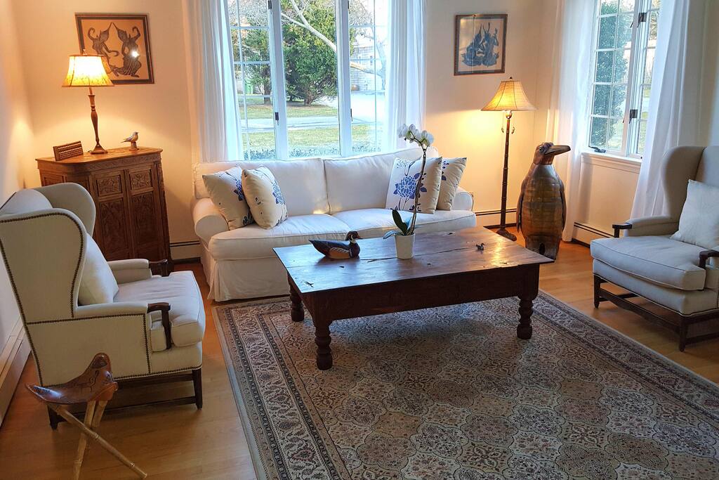 Sunken living room with white brick see through fireplace to family room