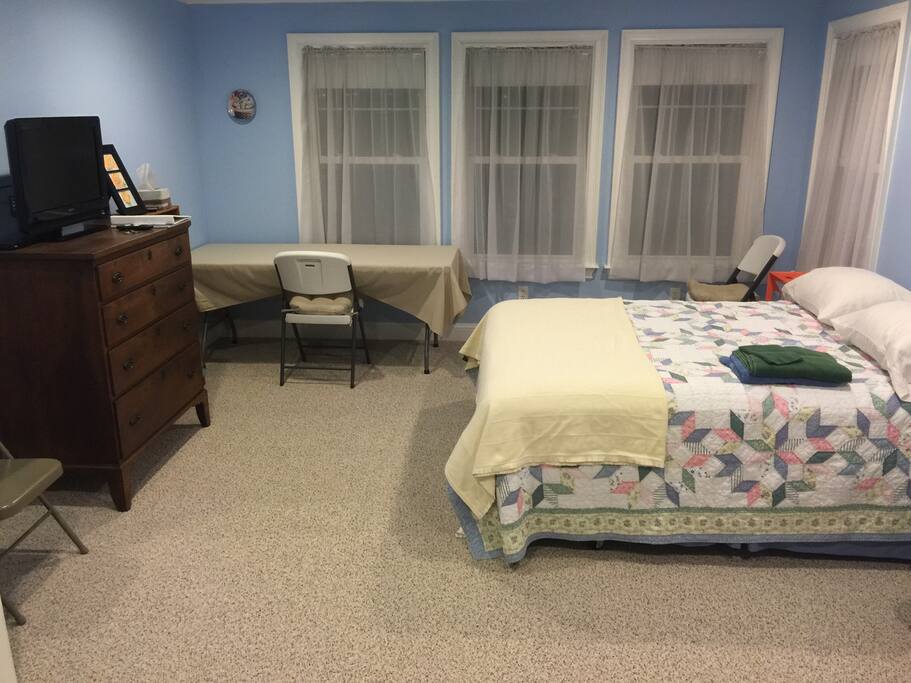 Queen bed, full-sized dresser, large table, and HD TV w/ basic cable.