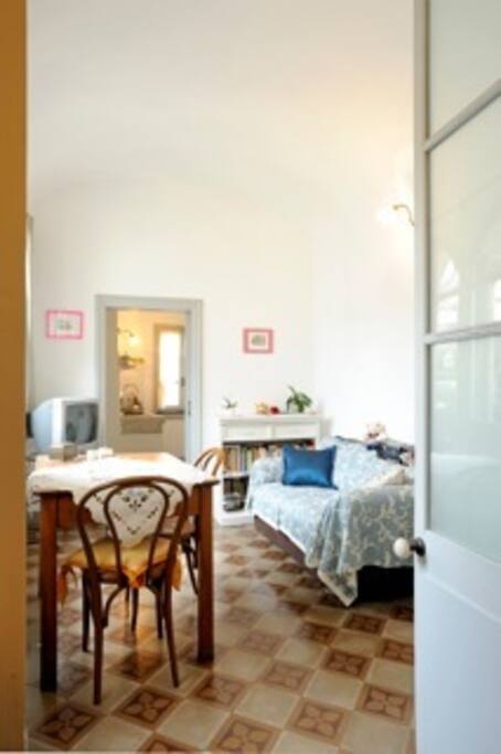 living area with full kitchen, dining table and TV