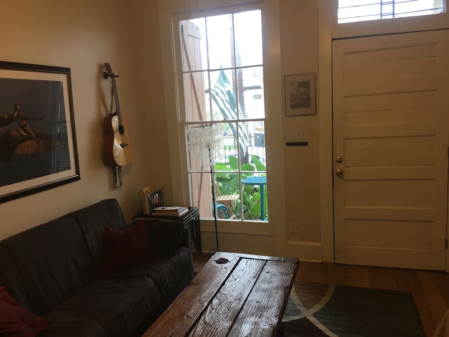 Huge historic front window overlooking porch and yard.
