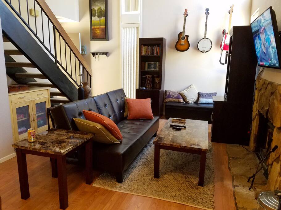 Cozy living room with fireplace and flatscreen TV with cable and xbox.