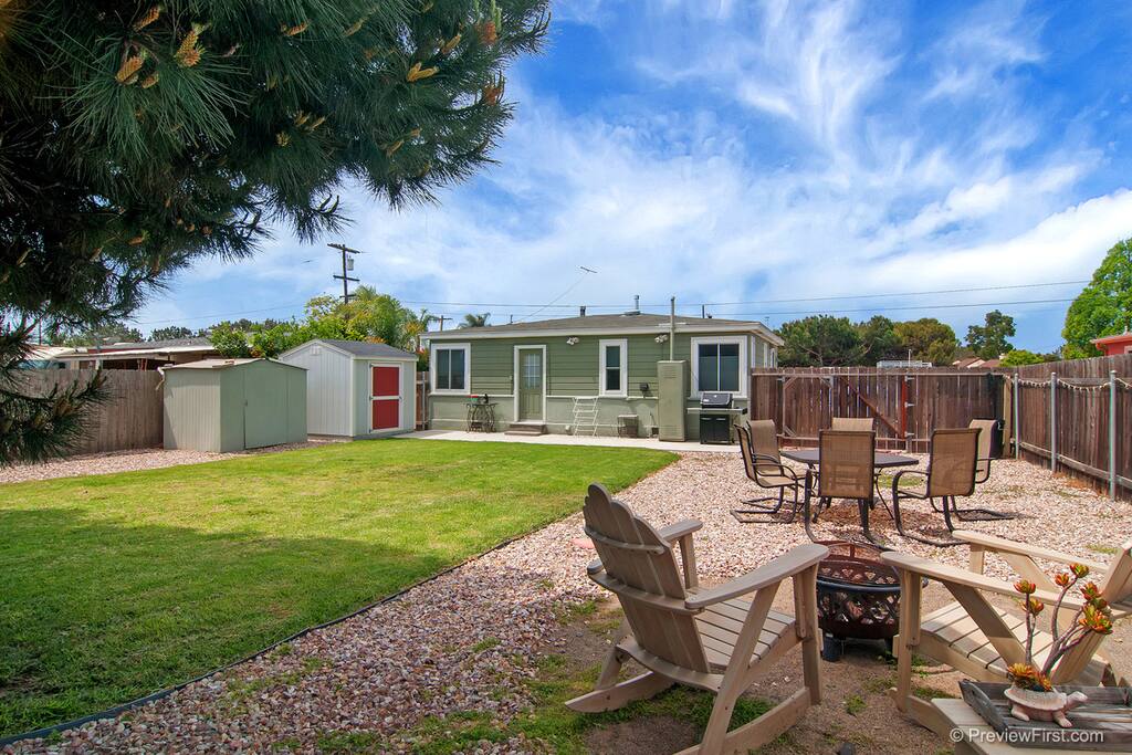 The property's highlight is the spacious backyard, with a grill, plenty of seating an outdoor fire pit and room to play