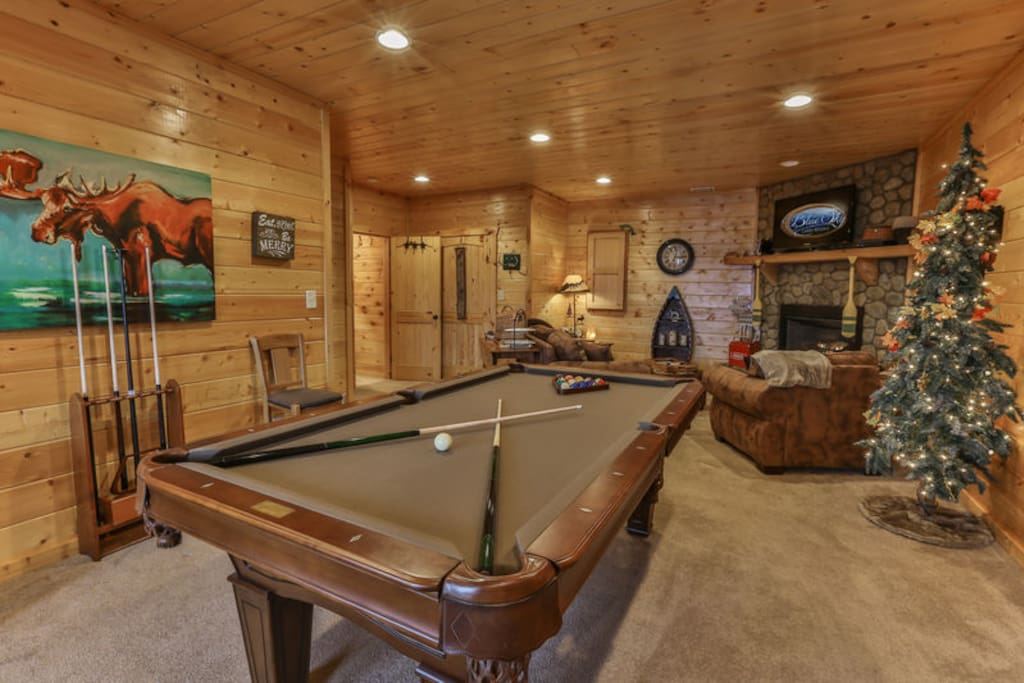Terrace level great room with pool table and 40 inch TV above the custom stone gas fireplace
