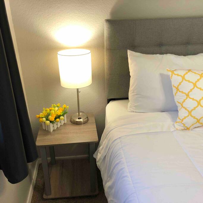 Bedside table with lamp that has an outlet right on it!